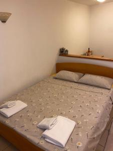 a bed in a room with two towels on it at zolina in Tivat