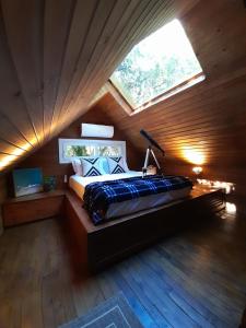 a bedroom with a bed in a room with a window at Vila Nambu - Exclusive Pousada in Gramado