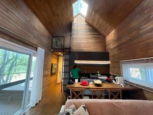 a kitchen with wooden walls and a table in a room at Vila Nambu - Exclusive Pousada in Gramado +92 photos