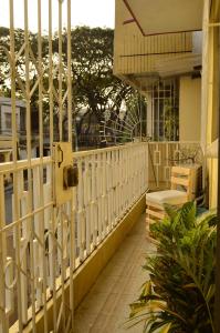 a balcony with a white fence and some plants at Pachamac House in Guayaquil