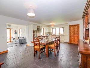 a kitchen and dining room with a table and chairs at Cherry Blossom Cottage in Ennis