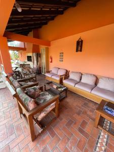 a living room with couches and tables in a room at Vila Rica Xangri-lá - 550 Metros do Mar in Xangri-lá