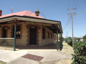 a building with a sign on the front of it at Poet's Recall Motel in Gundagai