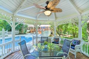 a screened porch with a glass table and chairs at Dobson Getaway with Private Pool and Game Room! in Dobson