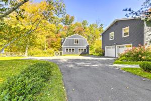 a driveway leading to a gray house with a garage at Modern Escape with Fire Pit, Near Lake Waramaug in Kent