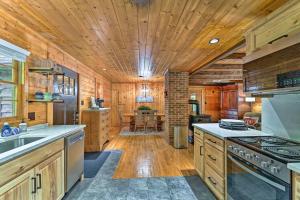 een keuken met houten wanden en een houten plafond bij Peaceful Moravian Falls Cabin Near Fishing! in Wilkesboro