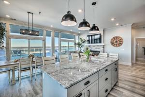 a kitchen and dining room with a view of the ocean at Watertown Condo with Resort-Style Amenities! in Watertown