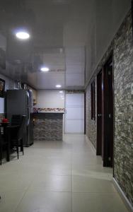 a room with a kitchen with a refrigerator and a table at Apartamento San Jose in Floridablanca