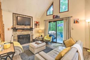 a living room with a couch and a fireplace at Colorful Pocono Lake Cabin with Deck and Fire Pit in Pocono Lake