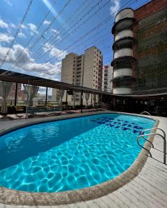 a swimming pool on the roof of a building at Hotel Ciudad Bonita in Bucaramanga