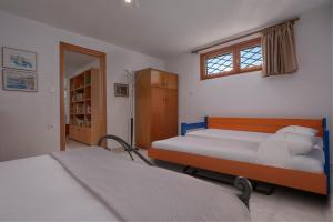 a bedroom with two beds and a window at Seaside Vourvourou Villa in Vourvourou