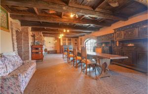 a living room with a wooden table and chairs at Castello Dei Diamanti in Belvedere Langhe