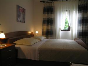 Postel nebo postele na pokoji v ubytování Apartments Pavicic Marija