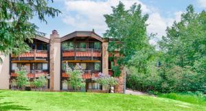 a large house with a balcony on a lawn at Laurelwood Condominiums 202 in Snowmass Village