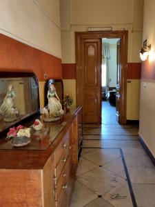 a kitchen with a dresser with a mirror and a refrigerator at Clement's House Hostel in Alexandria