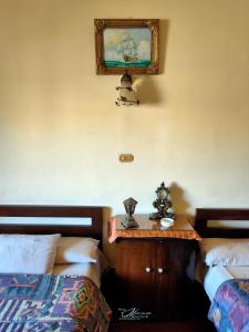 a bedroom with two beds and a table with a mirror at Clement's House Hostel in Alexandria