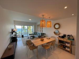 a kitchen and living room with a table and chairs at Aquarella Beachfront 2BR Sunset Juan Dolio in La Puntica de Juan Dolio