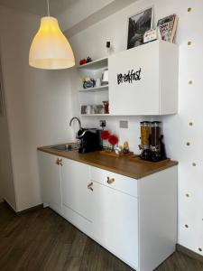 a kitchen with white cabinets and a counter top at Sea fly guest house in Fiumicino