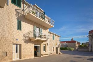 a building with two balconies on the side of it at Zora Residence in Kaštela