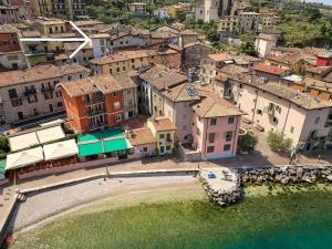 an aerial view of a town with a beach and buildings at Dependance in Malcesine