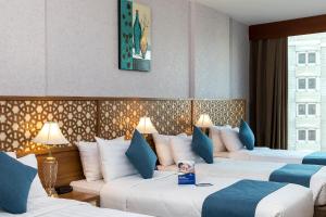 Postel nebo postele na pokoji v ubytování Sunrise Ajyad Hotel