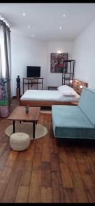 Appartements d'Hôtes Marciloui في أنتسيرابي: غرفة معيشة بسريرين وطاولة