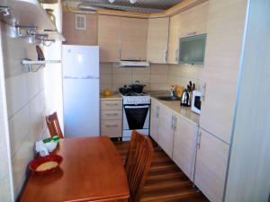a kitchen with a table and a white refrigerator at Best-BishkekCity Apartments 2 in Bishkek