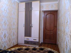 a room with a closet and a cabinet and a door at Best-BishkekCity Apartments 2 in Bishkek