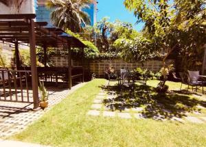 a patio with a lawn with a table and chairs at The Hub District Garden Suites in Manila