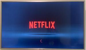 a sign that says netflix on a blue wall at The Hub District Garden Suites in Manila