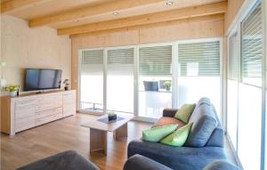 a living room with a couch and a tv at Ferienhaus 4 Wolfsschlucht in Gondenbrett