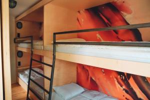 a bunk bed room with two bunk beds and a painting at Den Alen Arbed's Büro in Kayl