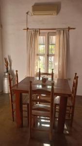 a dining room table with chairs and a window at Apartamento Cerrito in San Rafael