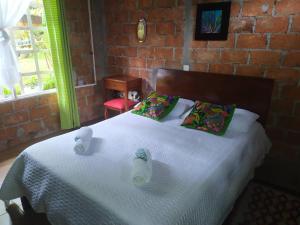 a bedroom with a bed with two ducks on it at Eco Lodge Villa Laura 