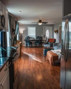 a kitchen and a living room with a table at Sandusky Bay Hot Tub, Gym, Patio, Games, Recreation Watercraft, Waterside Home, check it out! in Port Clinton