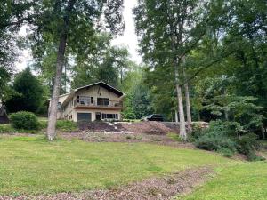 a house sitting on top of a lush green yard at Cozy, Lake Lanier property with amazing views in Dawsonville
