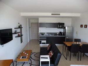 a living room with a couch and a table at Condo Wyndham Hotel, Nordelta Bay, Piscina con arancel, Parking in Tigre