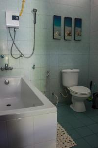 a bathroom with a toilet and a sink and a tub at Baan Sawainam in Ko Tao