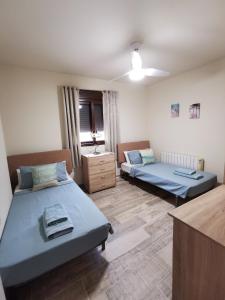a room with two beds and a dresser in it at Villa Casa Segunda in Lliria