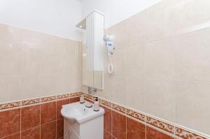 a bathroom with a sink and a mirror at House Hacienda in Tribunj +26 photos