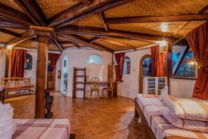 a bedroom with two beds and a table in a room at Atremaru Jungle Retreat in Puerto Princesa City