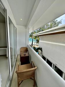 a balcony with a chair and a window at Calypso Beach and Dive Resort in Boracay