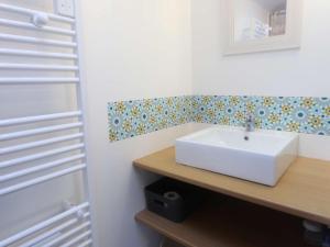 a bathroom with a white sink on a wooden counter at Maison rénovée à Bénodet, 3 étoiles, centre-ville, proche plage et commerces - FR-1-481-125 in Bénodet +7 photos