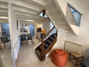 a staircase leading to a living room and a kitchen at Maison rénovée à Bénodet, 3 étoiles, centre-ville, proche plage et commerces - FR-1-481-125 in Bénodet