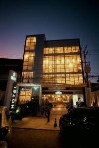 a large building with a lot of windows at night at Uno Hotel in Carpina