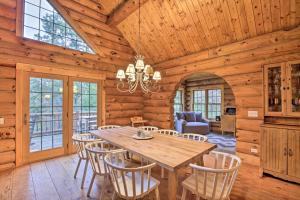 a dining room with a wooden table and chairs at Splendid Family Cabin with Hot Tub and Grill! in Lake City