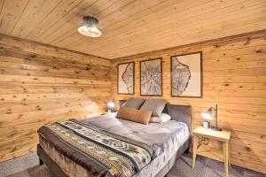 a bedroom with a bed in a wooden cabin at Splendid Family Cabin with Hot Tub and Grill! in Lake City