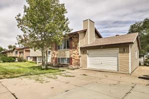 a house with a garage and a tree at Cozy Magna Apartment - Near Parks and Lakes! in West Valley City