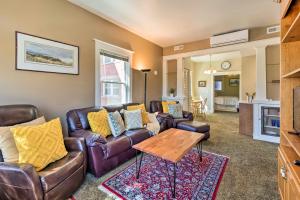 a living room with a couch and a table at Salt Lake City Condo Less Than 28 Mi to Ski Resort! in Salt Lake City