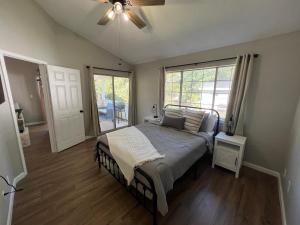 a bedroom with a bed and a ceiling fan at Mid City Condo in Huntsville